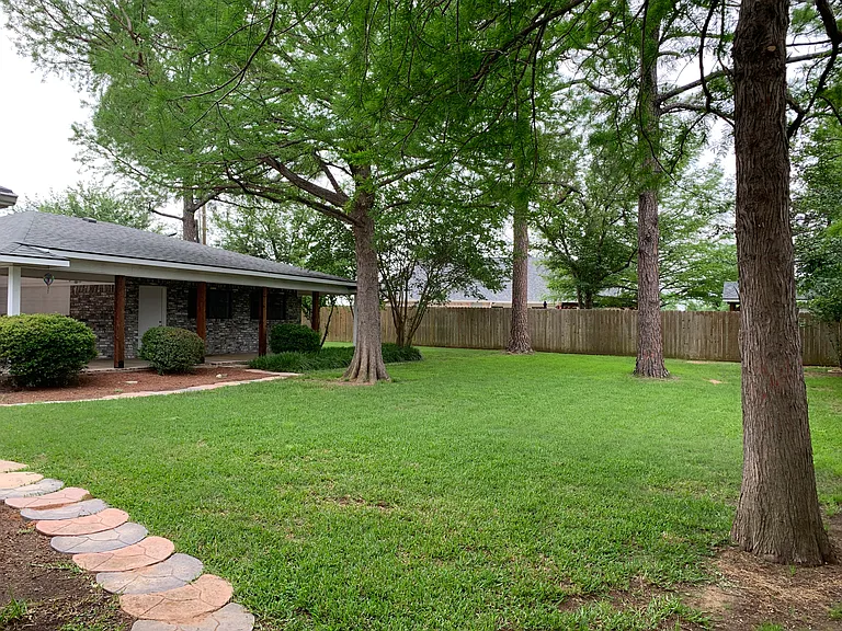 Backyard goes on forever, wraps around the back of detached Garage