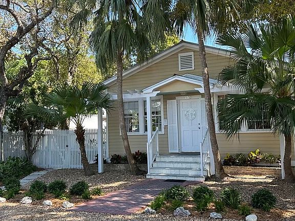 Lushly landscaped with tropical foilage.