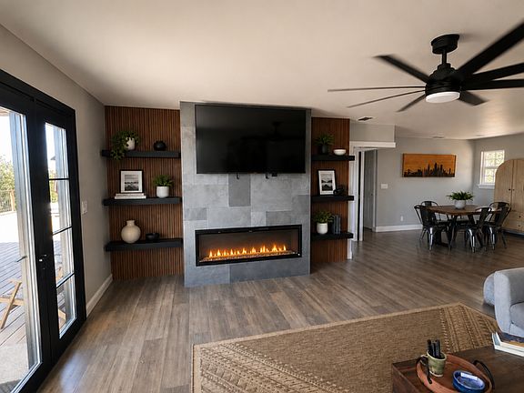 Open living room with Samsung TV and electric fireplace.