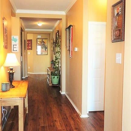 Distressed hickory laminate floors flow from entry to living area.