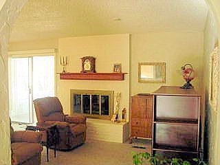 Another view from the archway of the den & fireplace