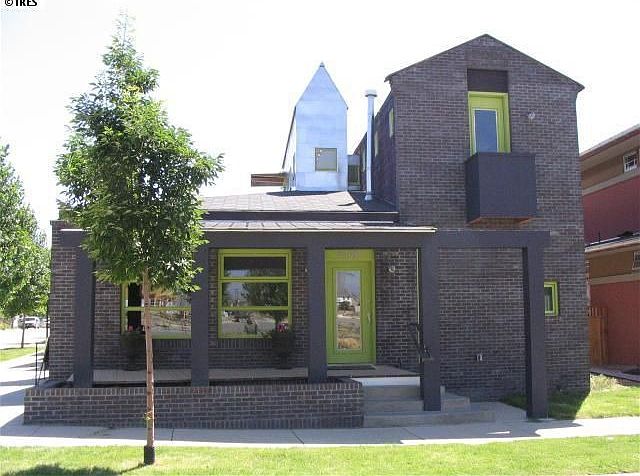 View of front (porch, Juliet balcony, rooftop deck, tower)