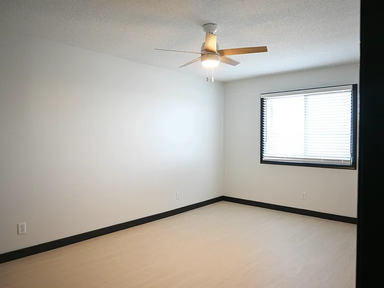 Large bedroom with window atHallway with black trim at Cielo 120.