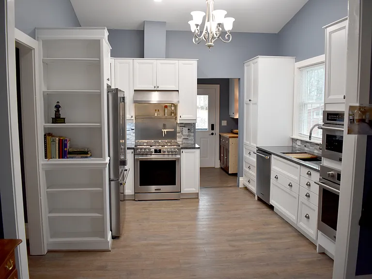 Full view of kitchen and laundry/mud room area from "keeping room" foyer. Note rolling island placed in Laundry/mud room.