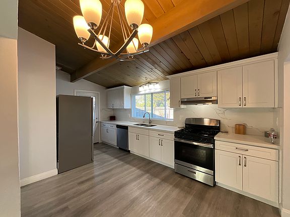 Beautiful kitchen dishwasher stove eating area in kitchen with laminate flooring
