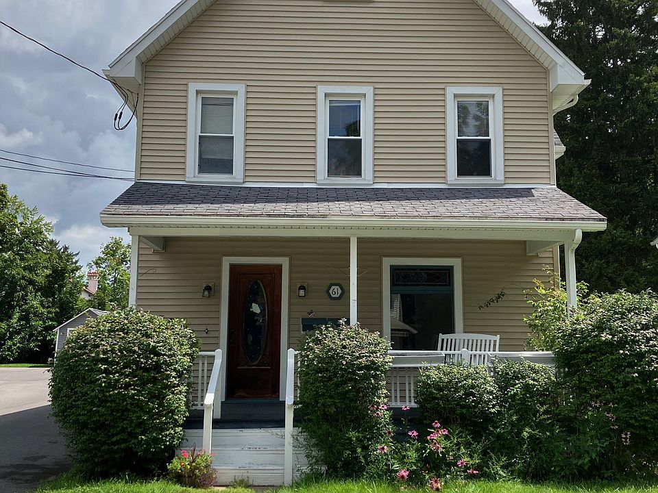 Welcome to 61 Cherry St. Shared front porch overlooking perennial garden on a quiet street.