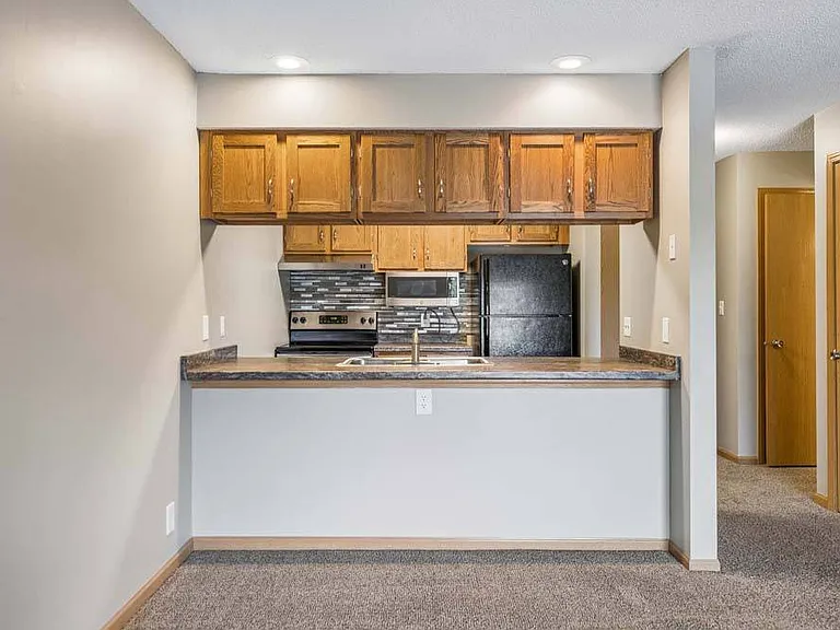 The open kitchen blends classic finishes with a convenient breakfast bar, creating a welcoming space for cooking, dining, and connecting.