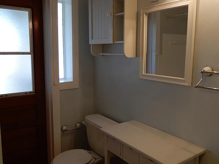 Guest bathroom with exterior door leading out to screened porch and pool areas. No need to travel through the main part of the house to change out of a wet bathing suit or to use the toilet.