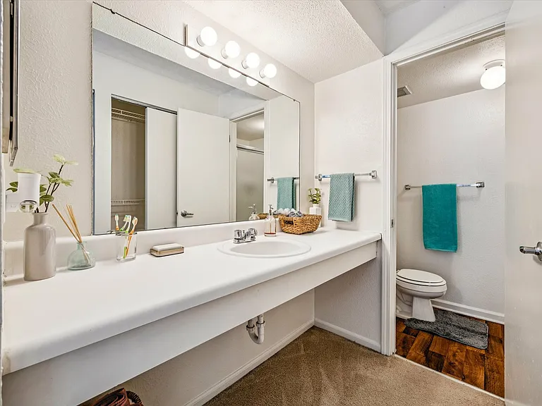 Get ready in style with a spacious vanity and modern decor at University Hills Apartments near the University of Toledo.