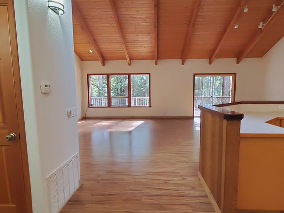 Entry and hall closet, with kitchen on right and great room ahead.