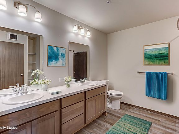 Large bathroom with TWO sinks and a full tub/shower. Linen storage shelves are also in the large bathroom.