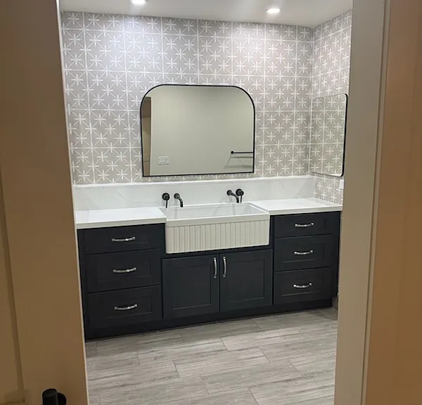 Unique farm sink is the one guests will remember. It has its own separate raised quartz box out top perfect for all the toiletries and 2 large mirrored medicine cabinets on each side. Custom wall tile makes this pop!