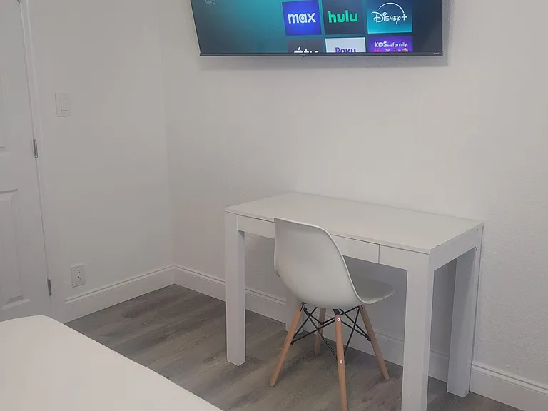 Desk with auxiliary chair and TV for entertainment