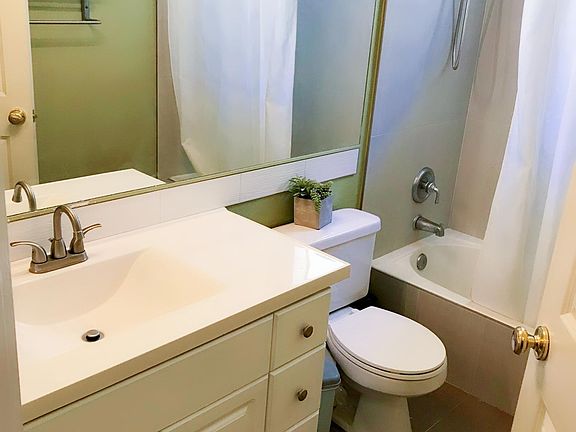 Freshly painted cabinet. Remodeled vanity and bathroom tiles.
