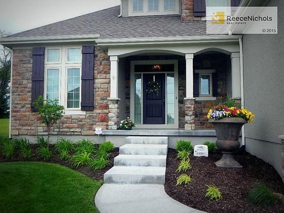 Welcoming front porch with beautiful stone faade.