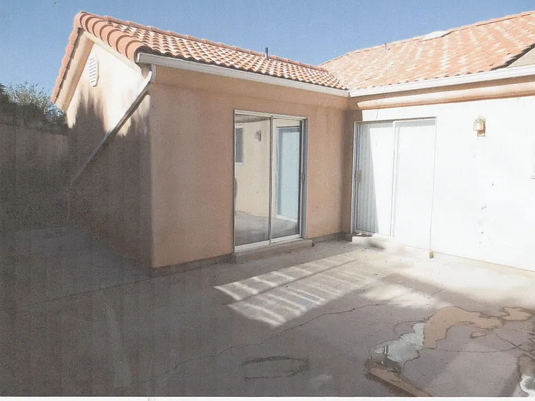 Double sliding doors, one to master bedroom, and the other to kitchen/dining room area