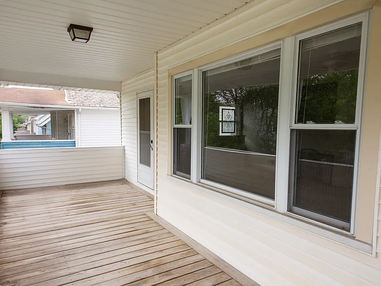 Expansive covered private balcony overlooking the tree-lined neighborhood. Perfect for relaxing outdoors.