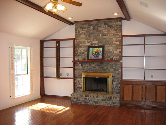 Sunny Living with beautiful wood floors, brick woodburning fireplace
