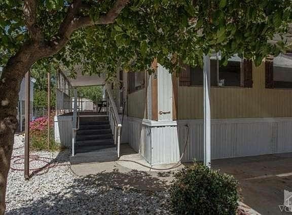 Covered porch and front entry. Great to enjoy a glass of lemonade made from your tree.