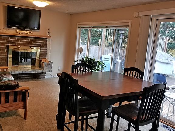 Cozy great room with breakfast bar, dining area and family room with fireplace overlooking deck and back yard 