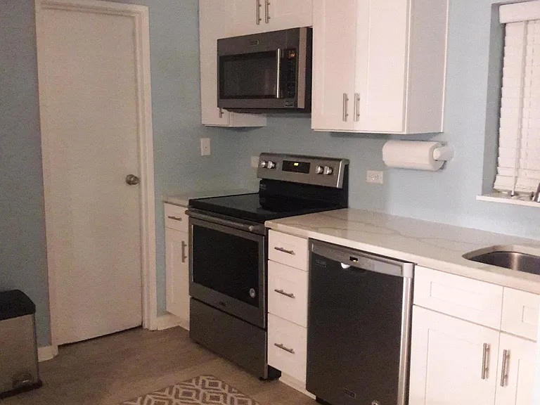 Kitchen, dishwasher, glass top stove and microwave. All Maytag appliances.