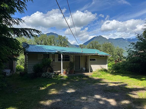 Front of house with large shed on the left.