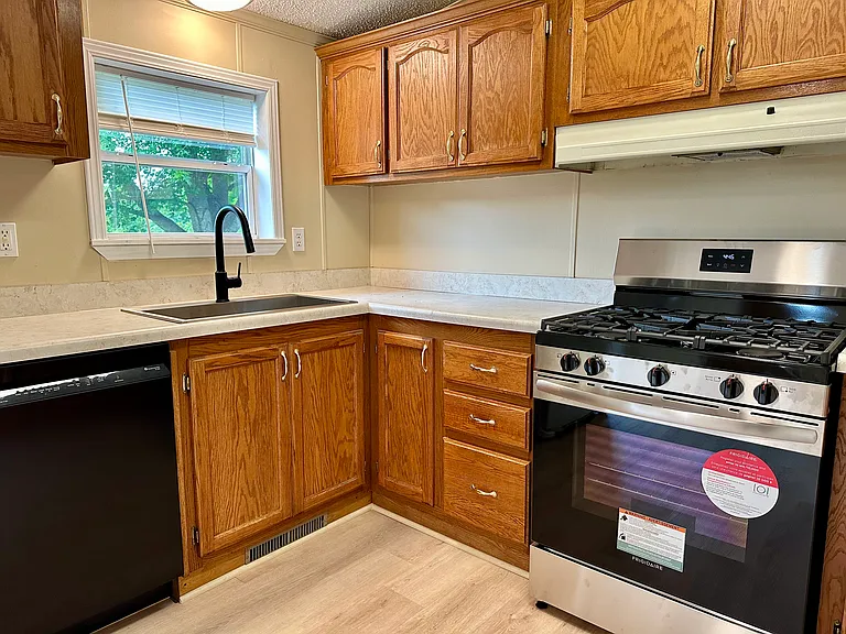 New dishwasher, stove, sink, and countertop.
