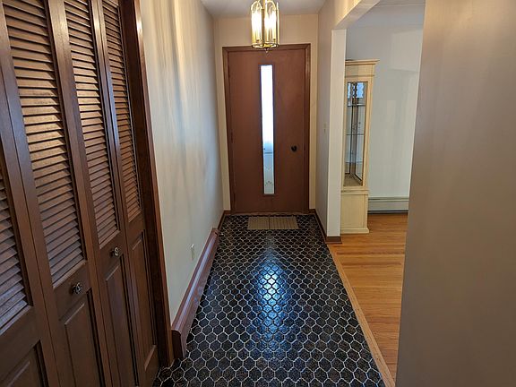 Front door and foyer with coat closet