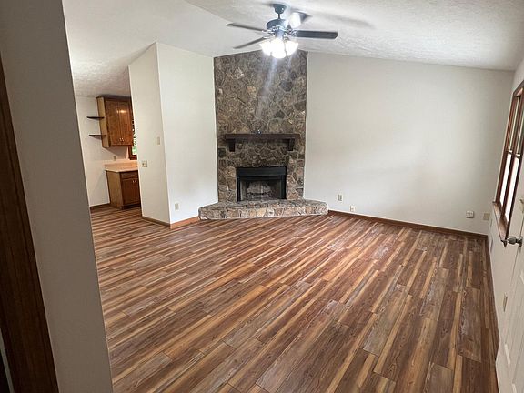 Large open living room with stone fireplace