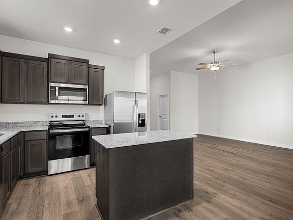 The kitchen has beautiful wood cabinetry.