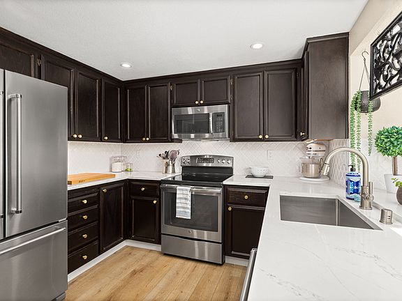 gourmet kitchen with Quartz counters, extra deep sink, and large refrigerator