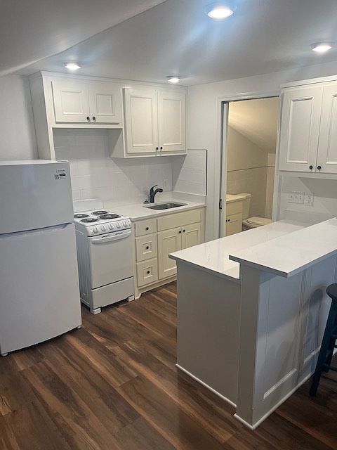 This studio offers a highly functional kitchen layout with plenty of storage. 
The sleek subway tile backsplash is easy to maintain, and the extended peninsula countertop provides a perfect spot for meal prep or a breakfast bar.