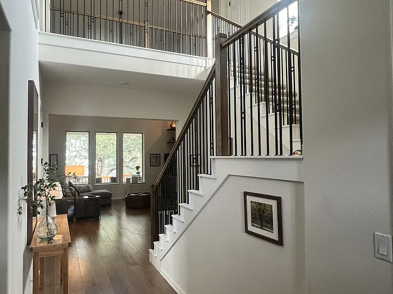 View from entryway looking towards living room and back of home. Kelly Wearstler chandelier.