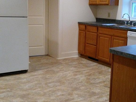 Kitchen with electric range, refrigerator, dishwasher and microwave