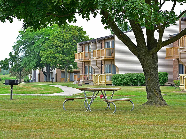 A picnic table and grill at Grand Bend Club Apartments