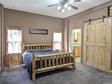 Large master bedroom with country style decor and large walk-in closet. Also has wall mounted flat screen T.V.