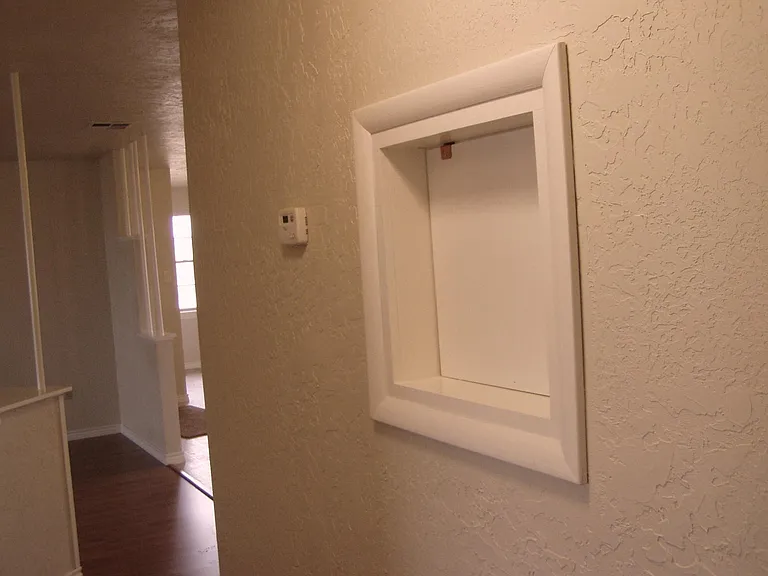 This is the laundry shoot it is located in the hallway.