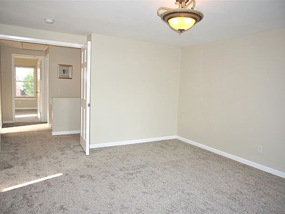 Primary bedroom with french doors, newer carpet/paint