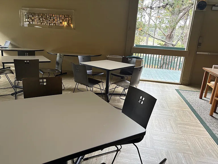 This clubhouse has no shortage of socialization space with many tables and chairs.