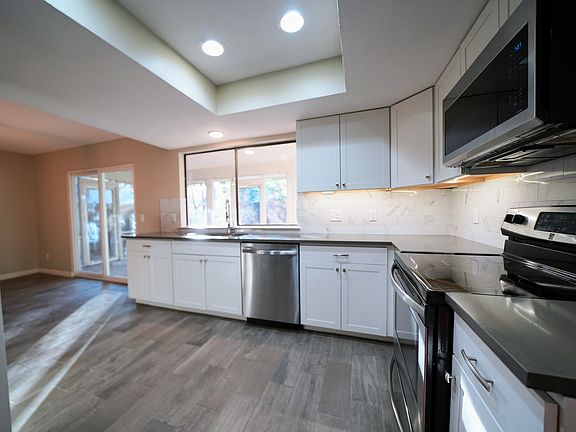 Large kitchen with modern fixtures, stainless appliances, silestone countertops, and plenty of natural light
