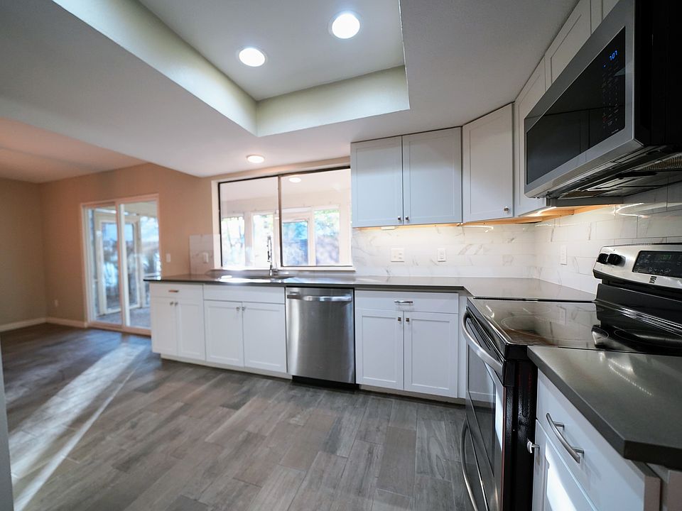 Large kitchen with modern fixtures, stainless appliances, silestone countertops, and plenty of natural light