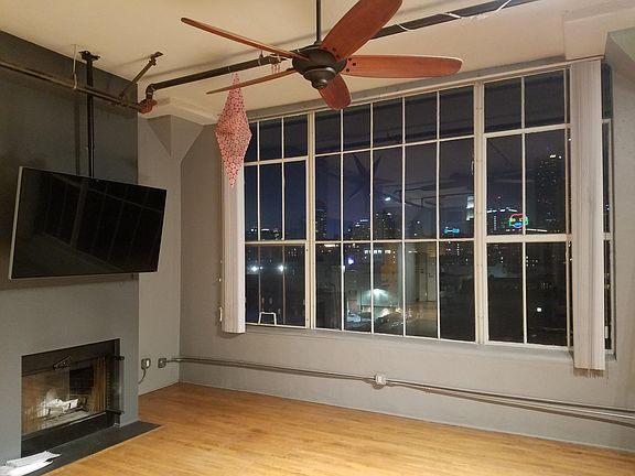 Living Room with ceiling fan, TV, & fireplace