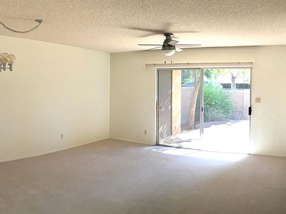 Dining and living area has sliding glass door opening onto b