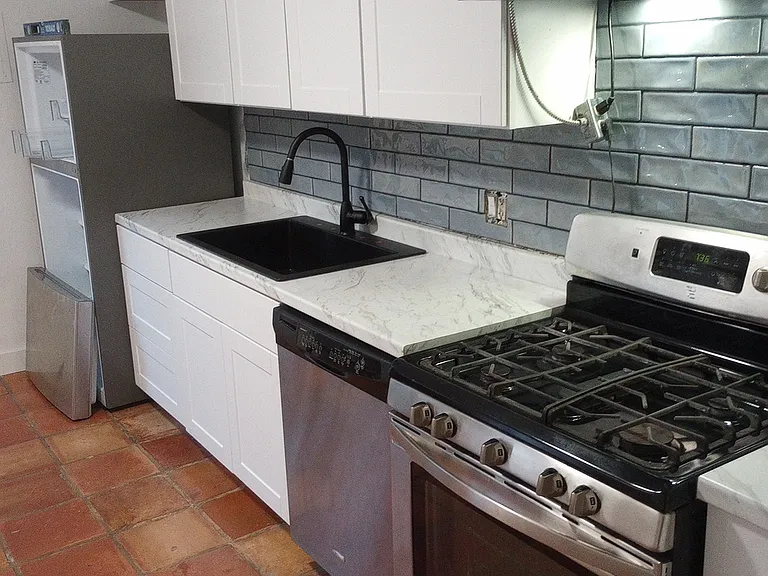 Remodeled kitchen with new SS dishwasher and vent hood to outside.