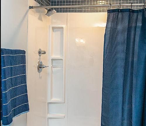 Master shower. Glass sliding door installed since picture