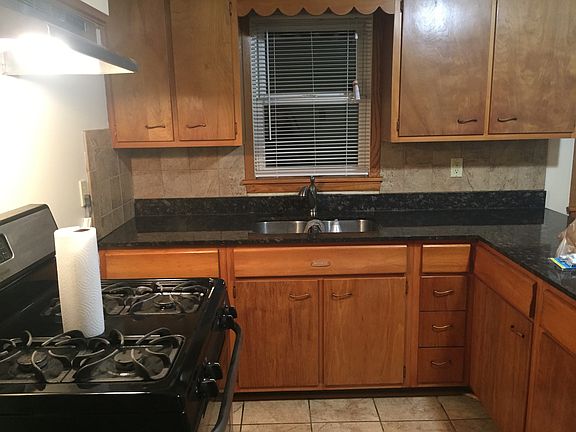 Kitchen has new fridge and gas stove