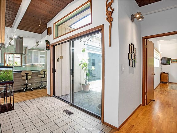 Entry and courtyard hallway to master bedroom on right