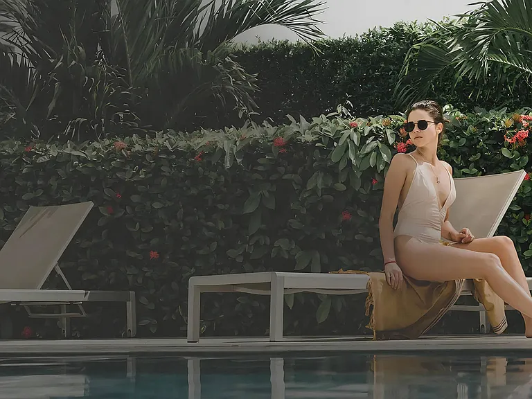 Poolside Sundeck Featuring Lounge Chairs and Greenery