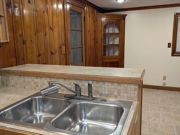 Sink and dining room with hutch