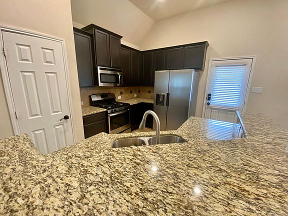 Granite counters, stainless steel appliances, plenty of cabinet and pantry space